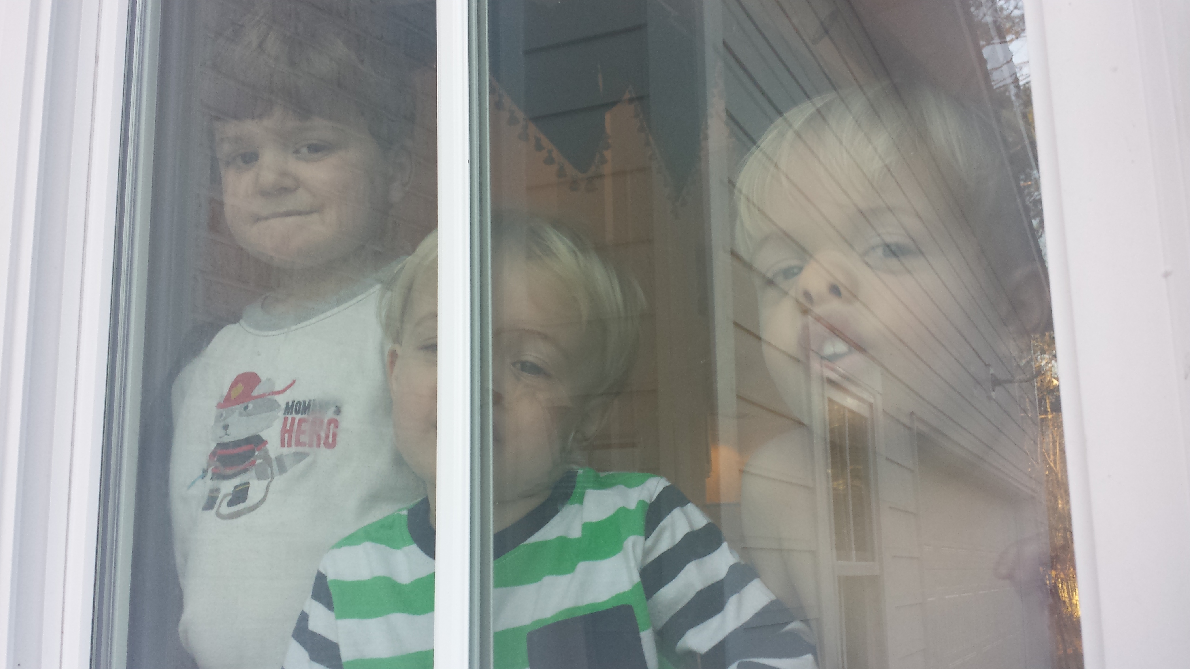 Three boys against a window