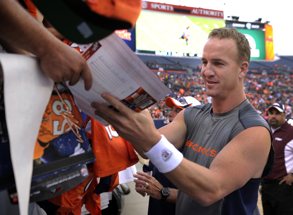 Manning signing autographs for fans